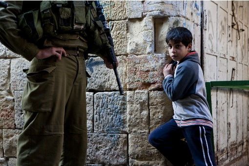 Israeli soldier and Palestinian boy in Hebron.